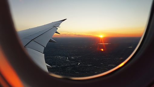 flying with an airplane sunset